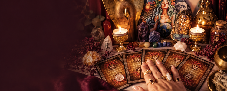 Tarot cards, candles and crystals on a reading table